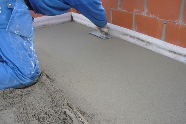 Чтобы выровнять бетонную стяжку используйте правило или гладилку